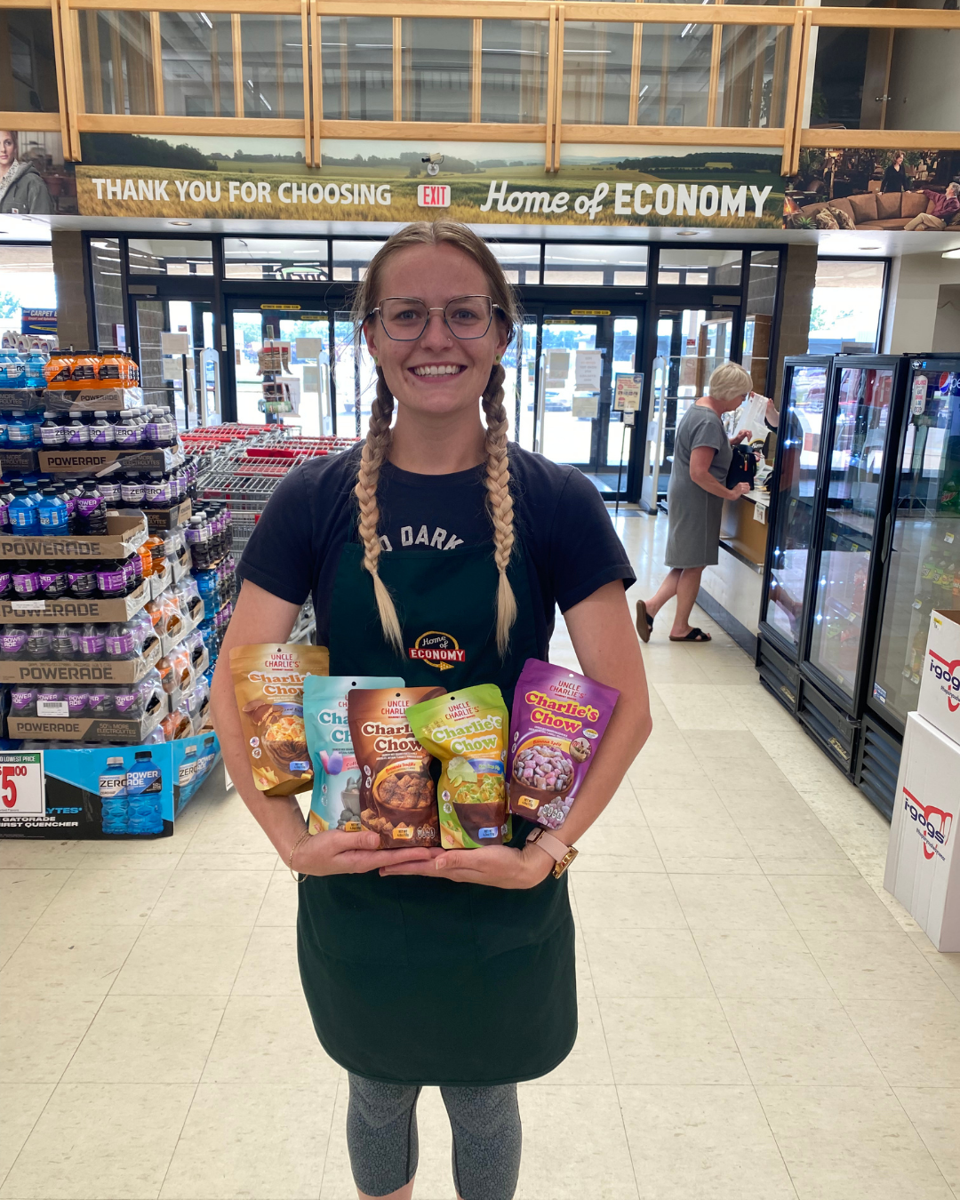 Home of Economy retail employee holding five Charlie’s Chow flavors
